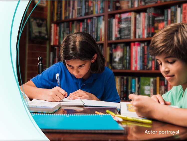 Two boys doing homework in a library